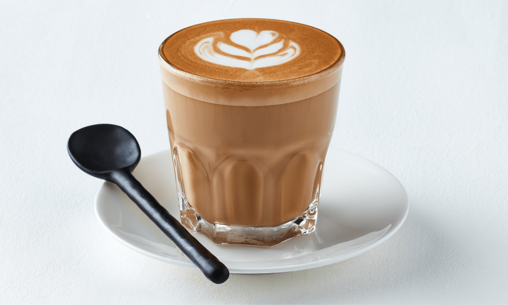 Cortado in glass with spoon